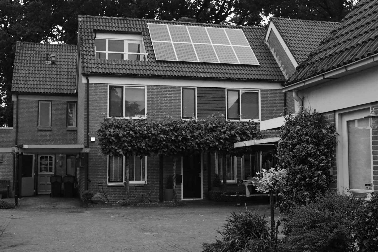 Grayscale photo of 2 storey house