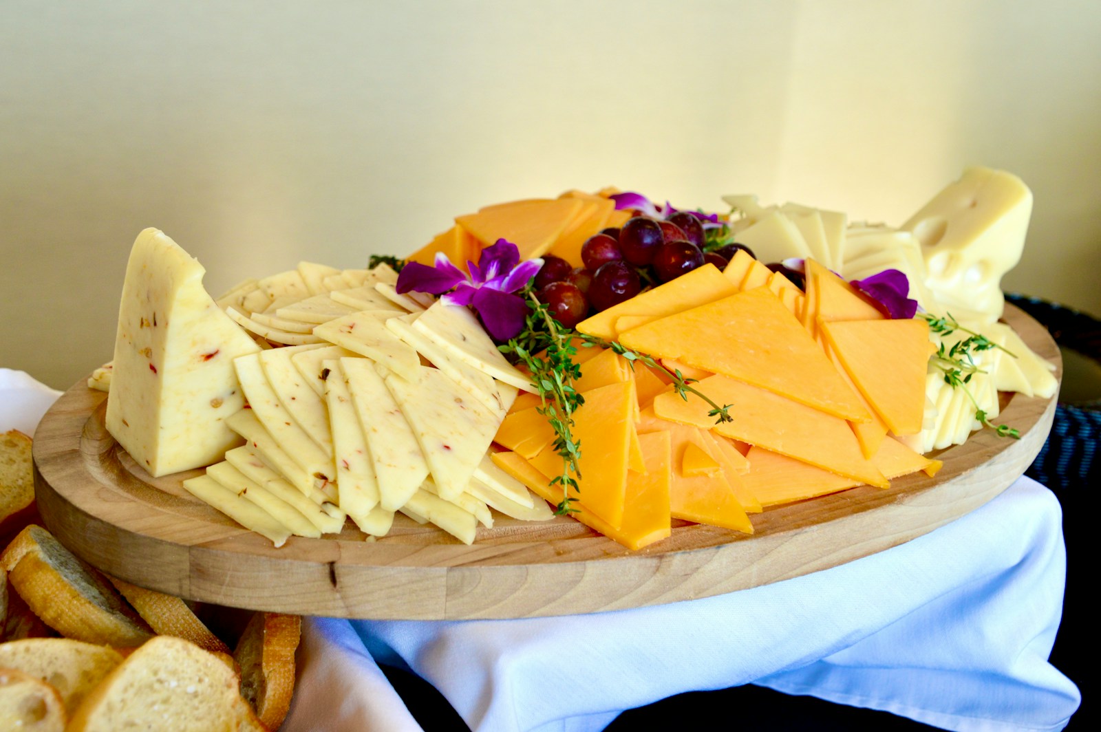 Sliced cheese on brown wooden chopping board