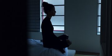 woman sitting on bed