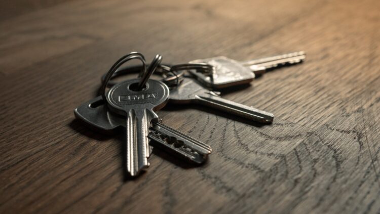 A bunch of keys sitting on top of a wooden table