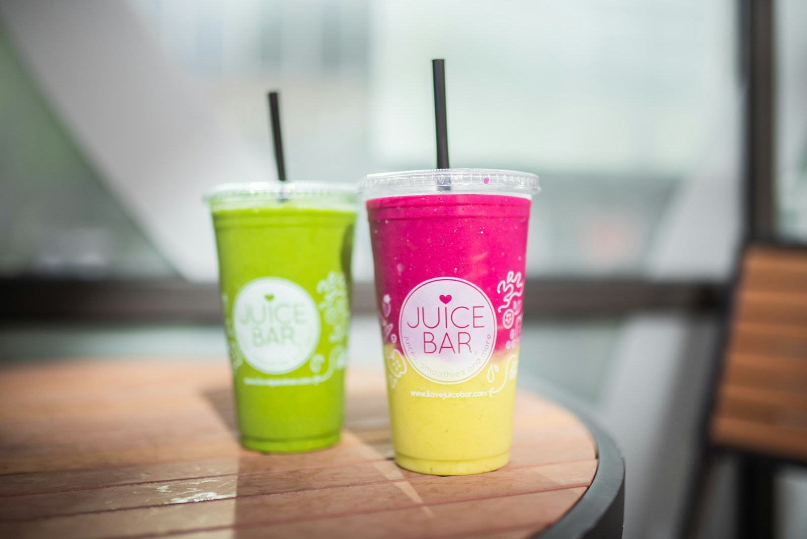 Two green and yellow plastic cups