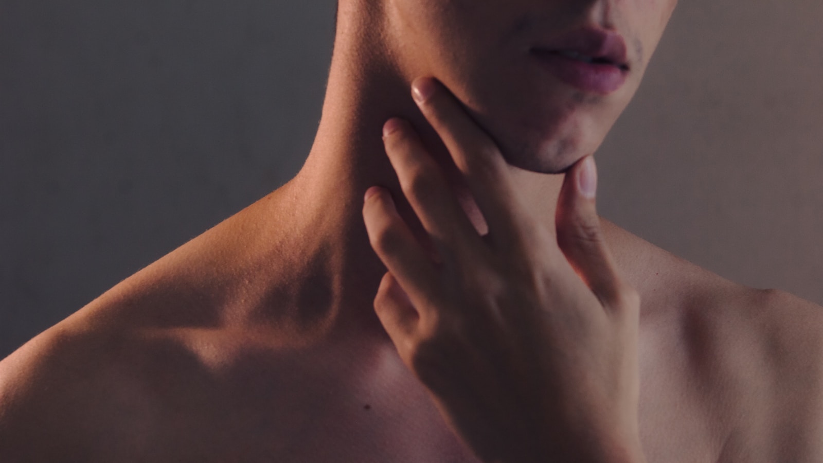 Topless woman with left hand on her chin