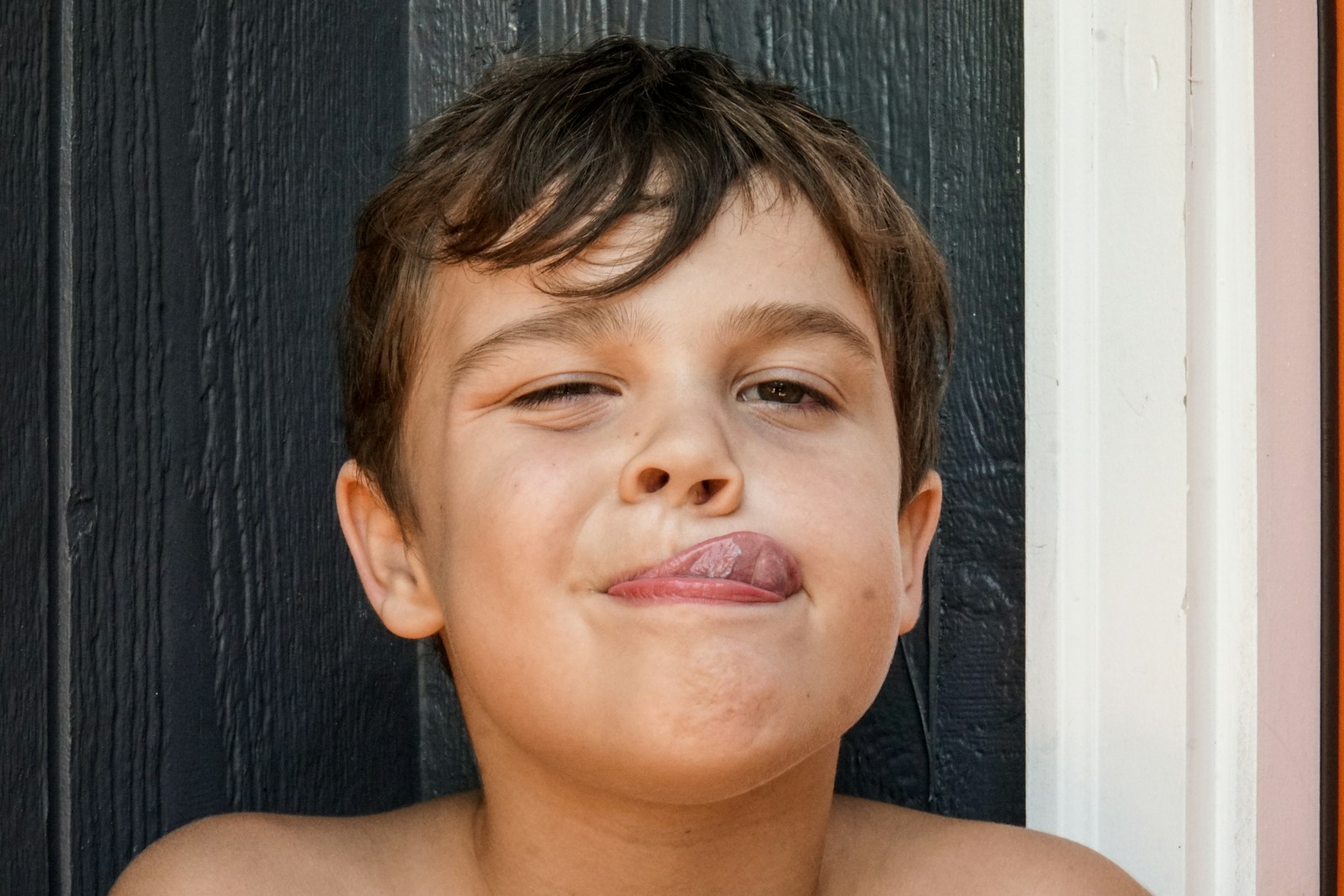 Boy with brown hair and red lip stick