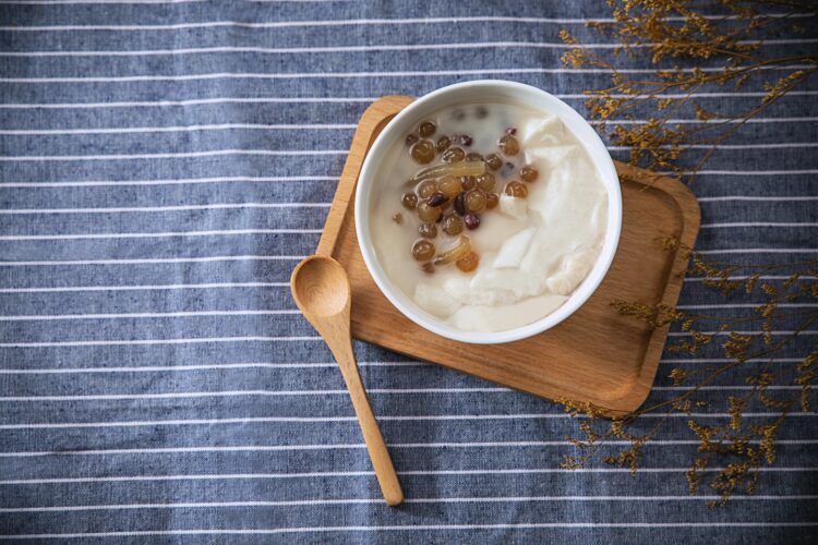 White ceramic bowl with brown wooden spoon