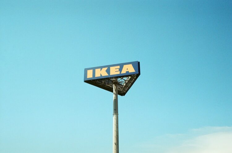 A ikea sign on a pole against a blue sky