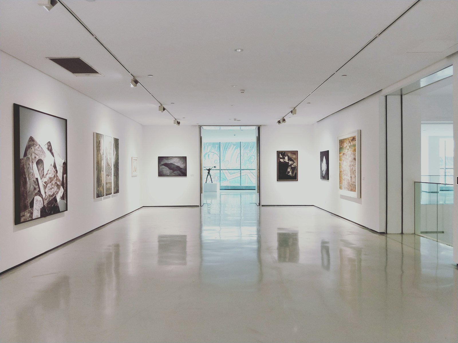 Assorted paintings on white painted wall