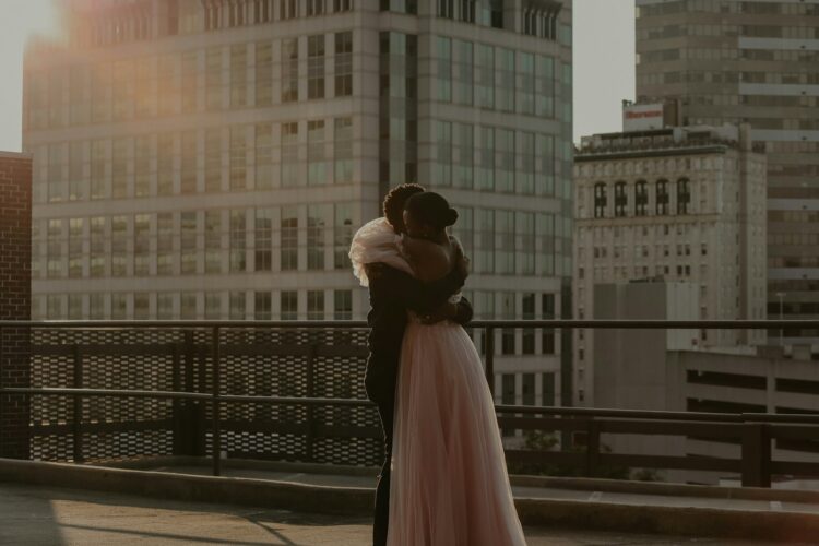 Woman in white dress standing on sidewalk during daytime