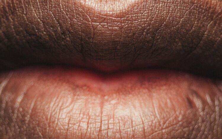 Persons lips with red lipstick
