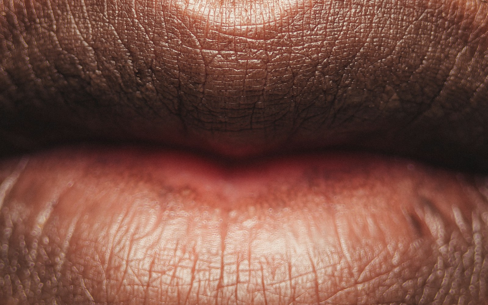Persons lips with red lipstick