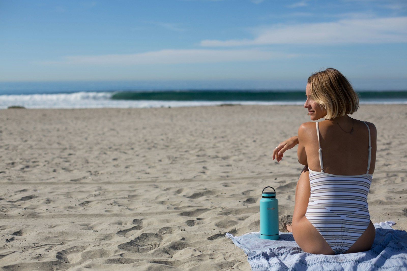 Woman sitting in front of shoreline