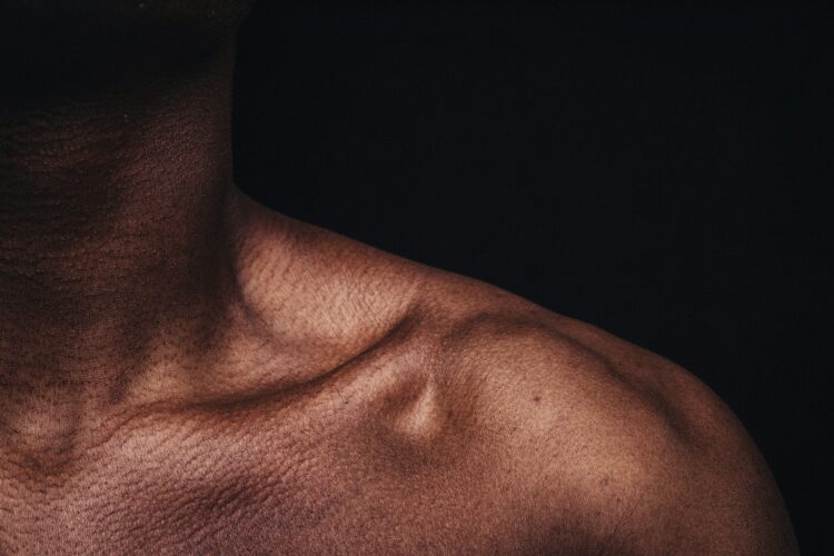 Topless man in black shirt