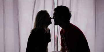 silhouette photo of woman and man close to each other