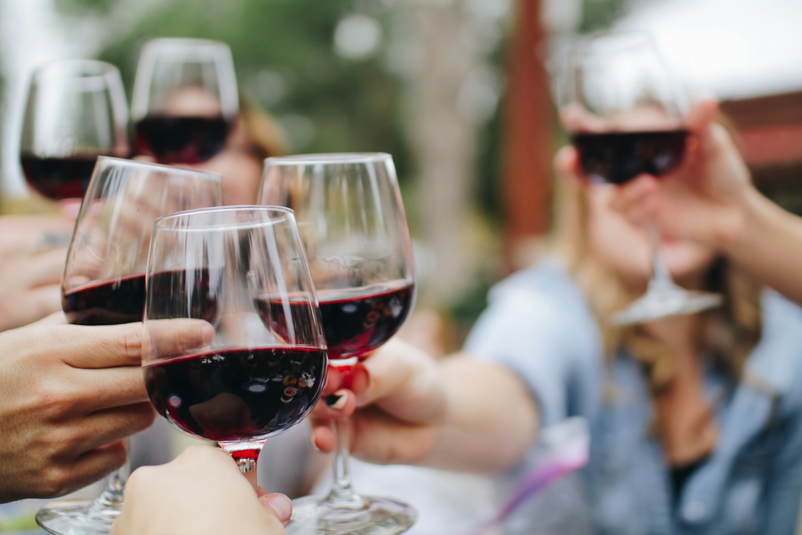 People tossing their clear wine glasses