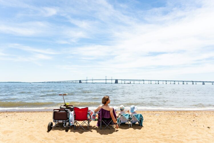 A woman sitting in a chair on the beach