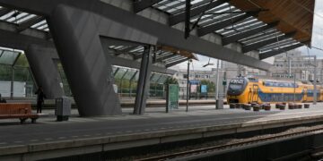 a yellow and blue train at a train station