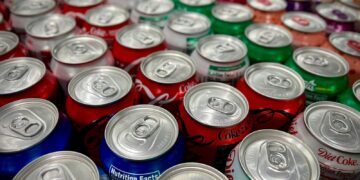 a large group of cans of soda