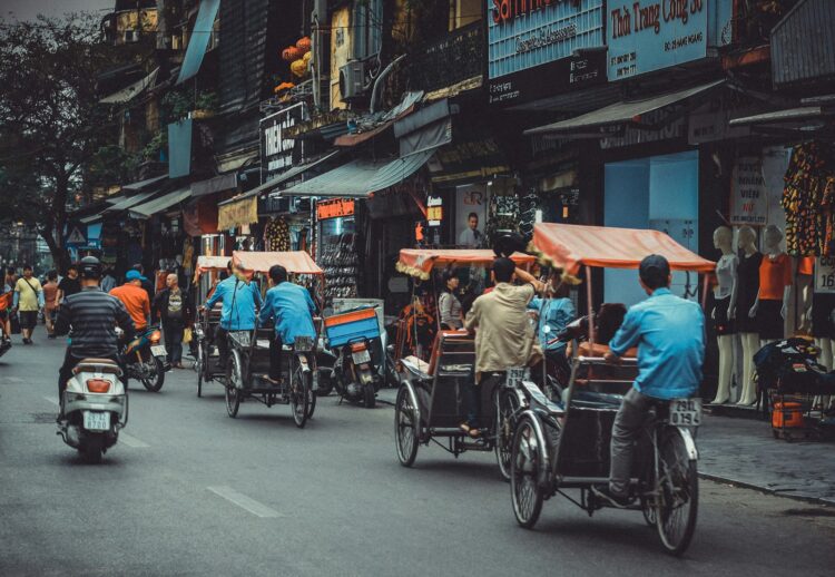 Man driving white motor scooter on road