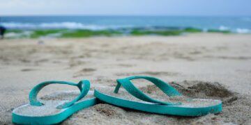 green plastic swimming goggles on beach during daytime