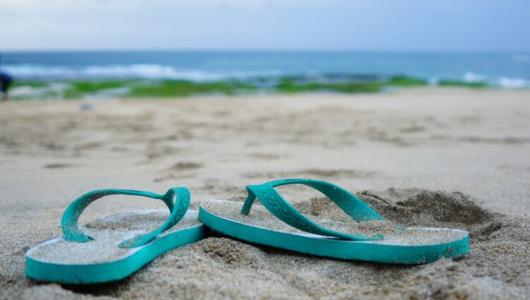 Green plastic swimming goggles on beach during daytime