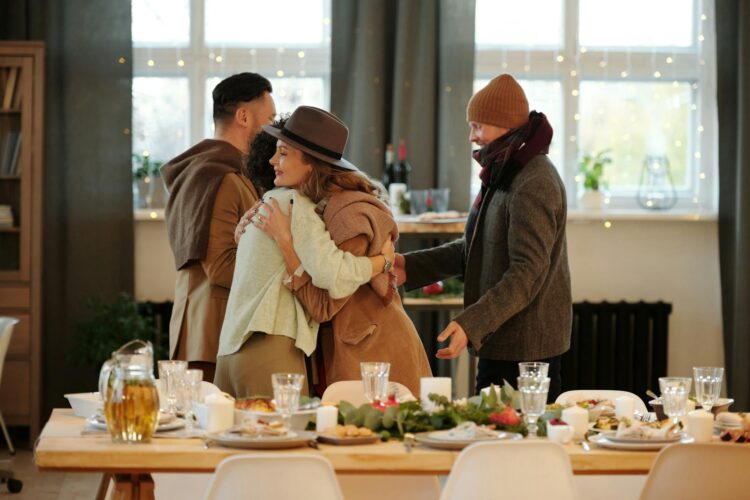 Family embracing and dining together indoors during festive holiday season
