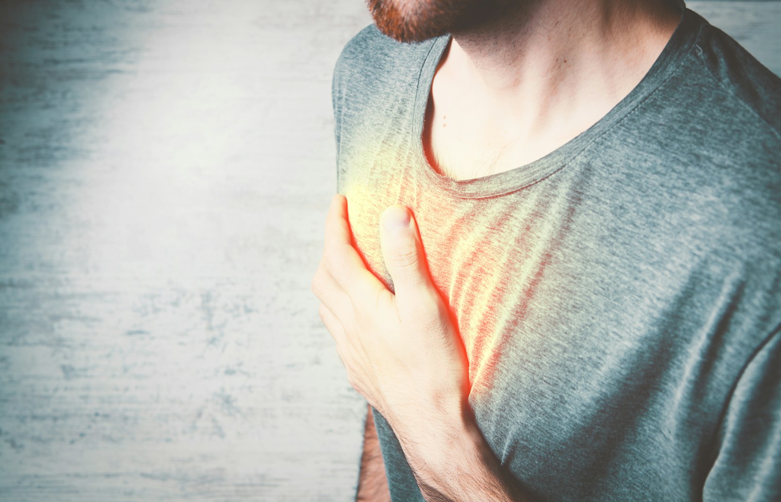 A man holding his chest with his hands