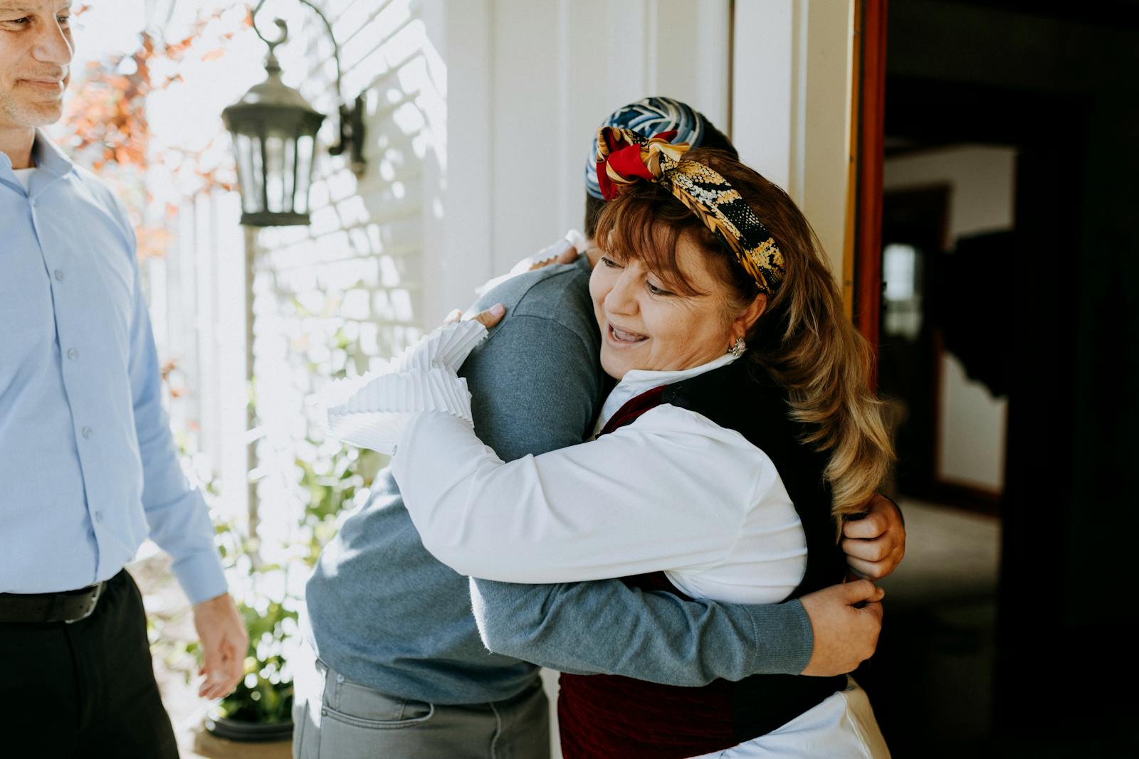 Joyful family reunion captured in a heartfelt embrace on a sunny day