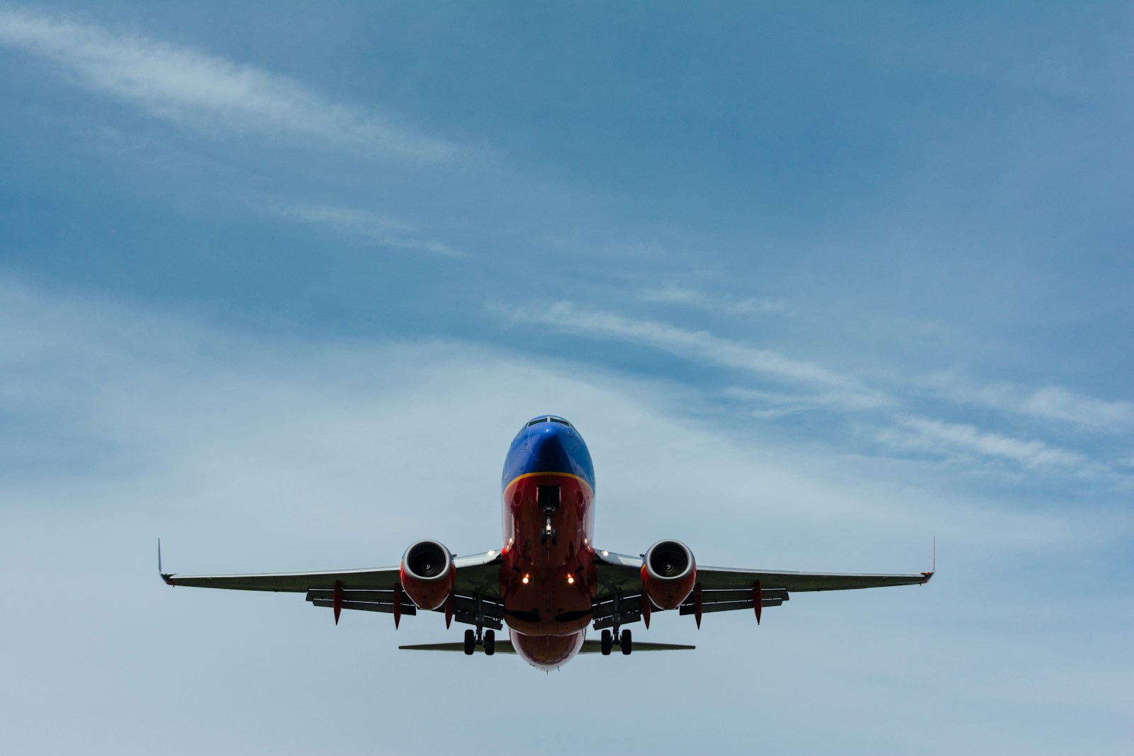 Blue and red airplane on sky
