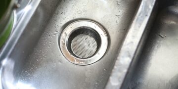 a stainless steel sink with a strainer in it