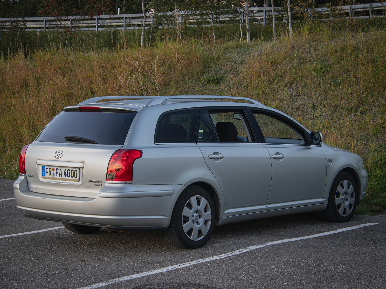 A silver car parked in a parking lot