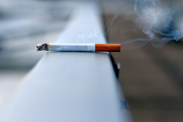 White cigarette stick on white wall