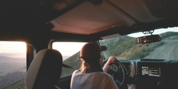 woman driving vehicle on road during daytime