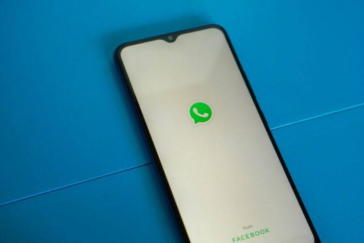 A white and black phone with a green whatsapp sticker on it