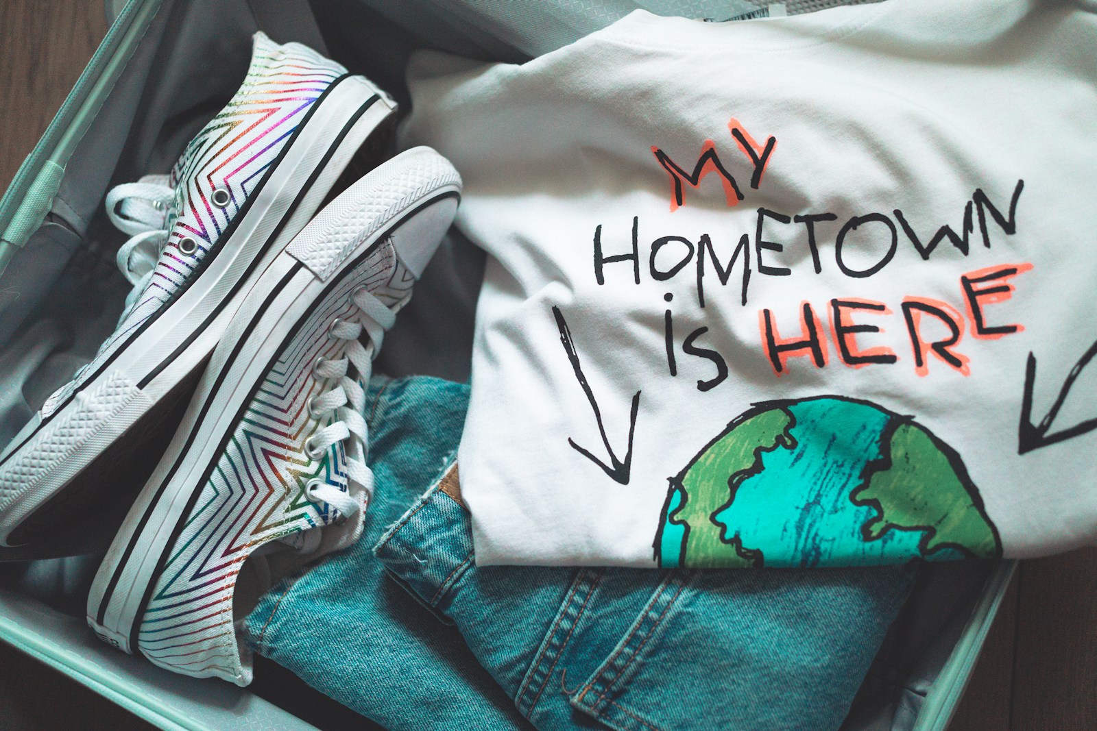 White and black shirt on blue denim jeans