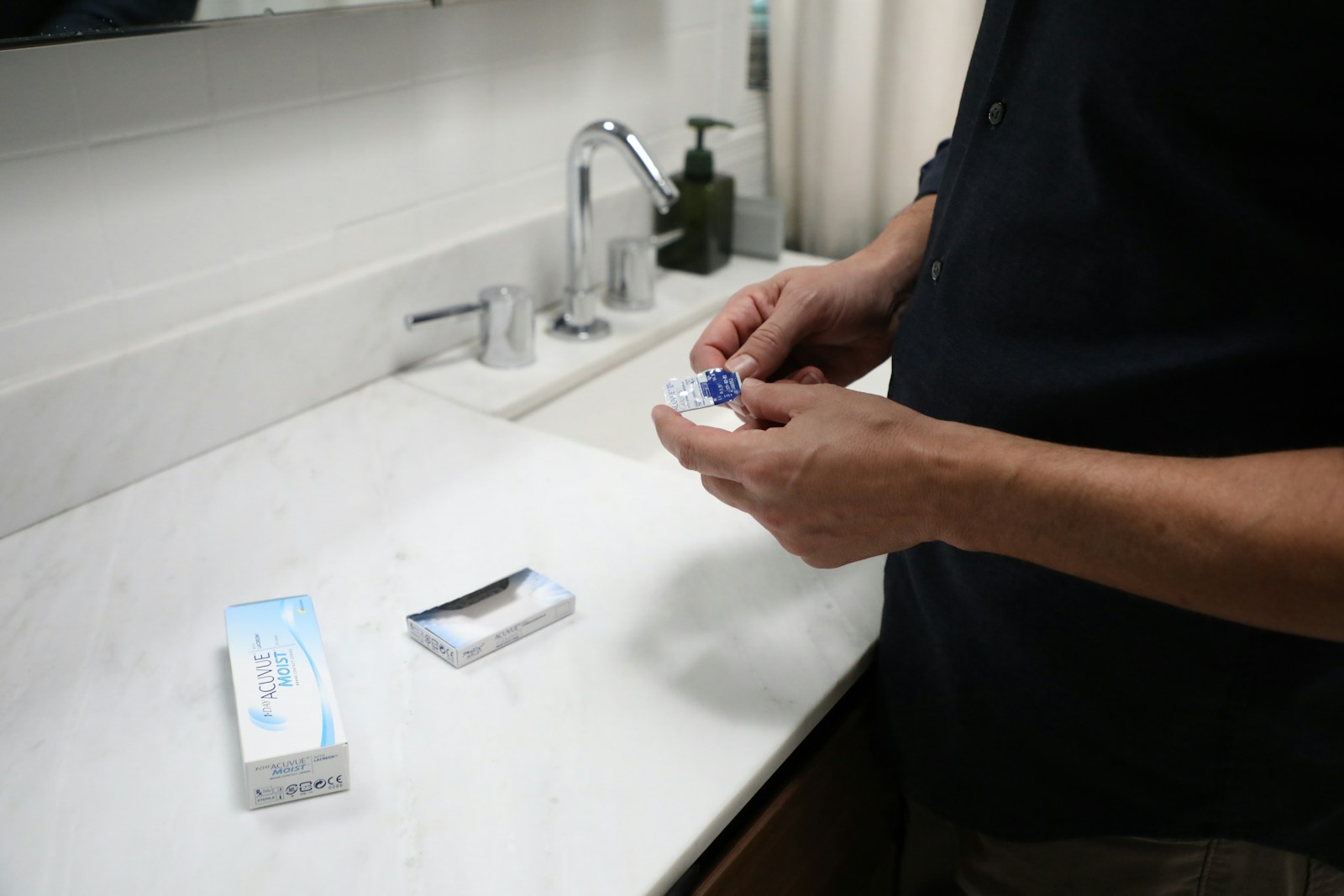 Person holding blue and white plastic pack