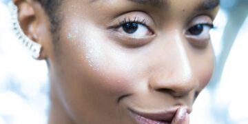 a close up of a person with a ring on her finger