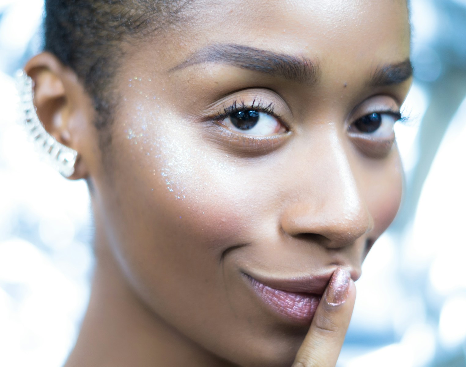 A close up of a person with a ring on her finger