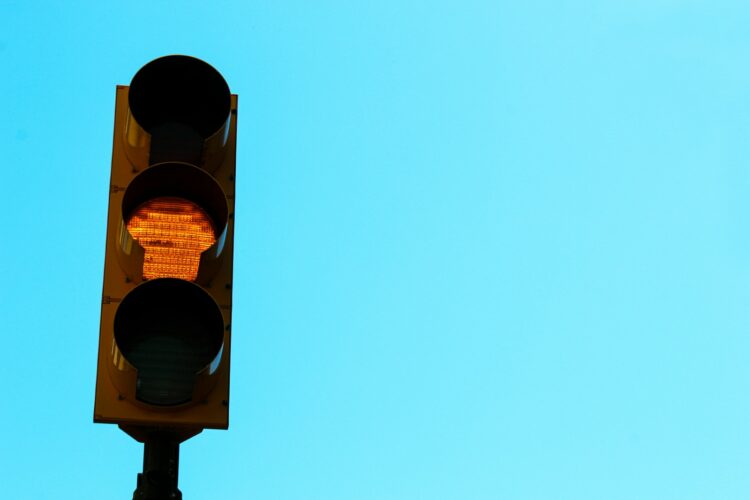 A traffic light with a blue sky in the background