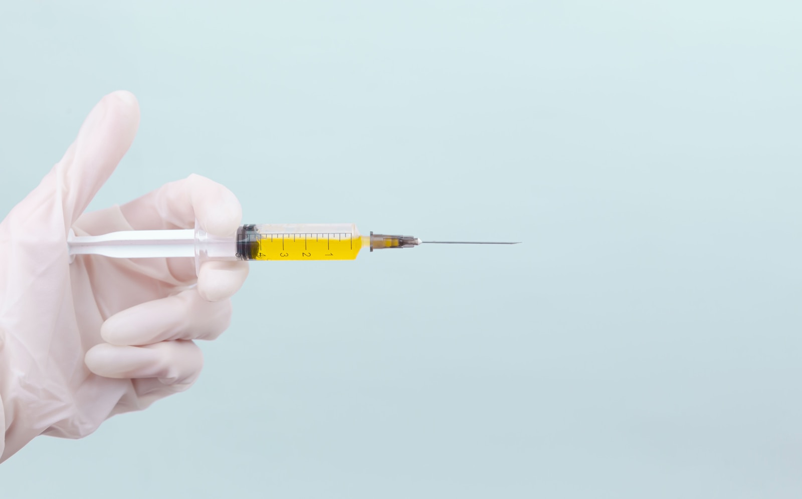 Person holding yellow and white pen