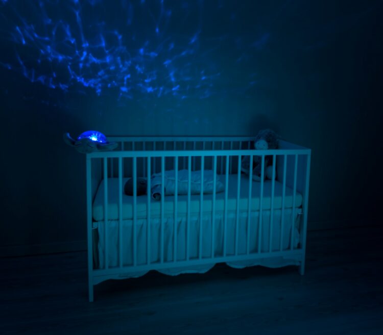 Baby's white wooden crib lowlight photography