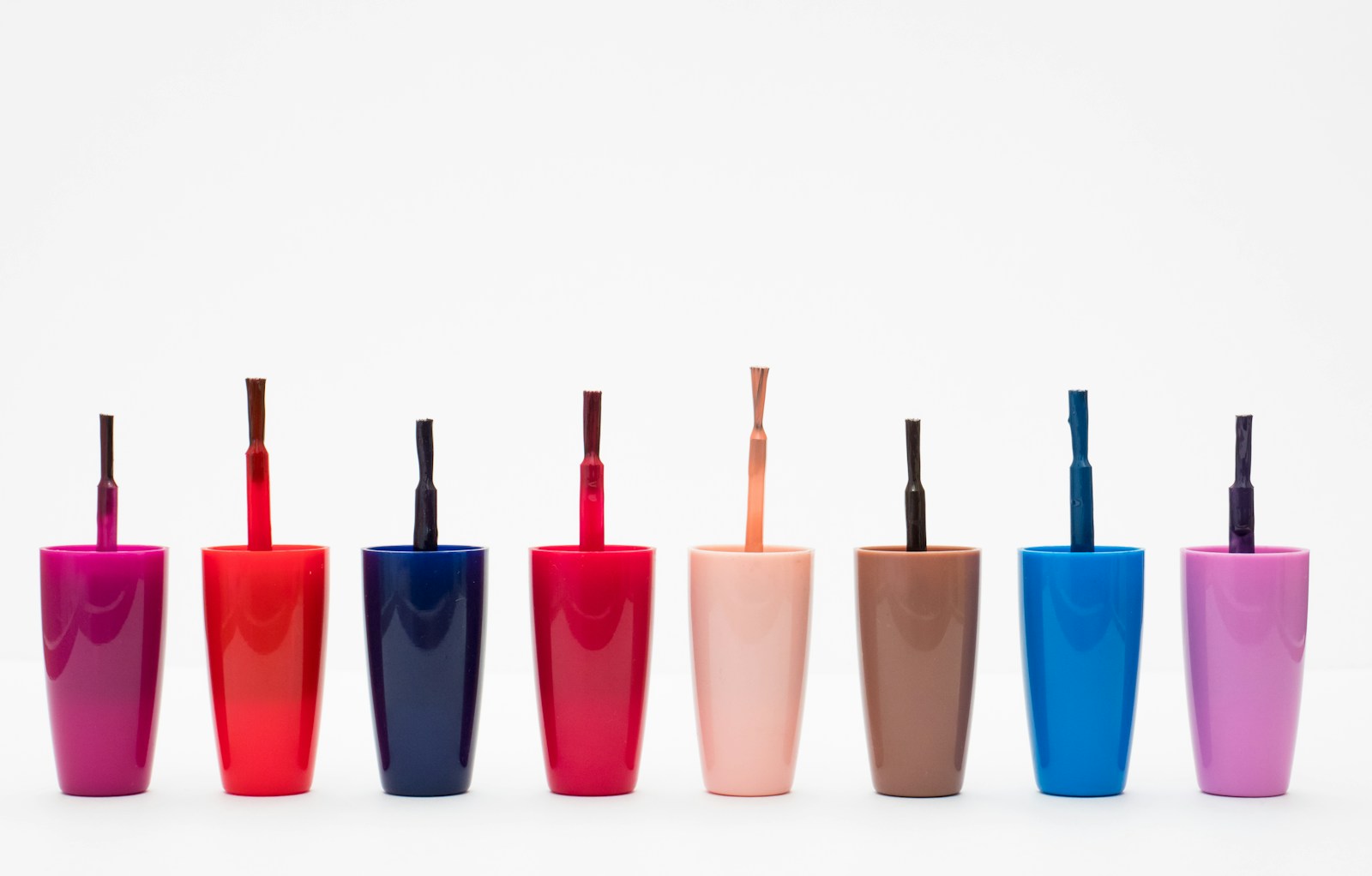 Eight assorted color glass bottles