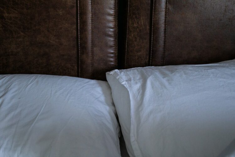 A close up of two pillows on a bed