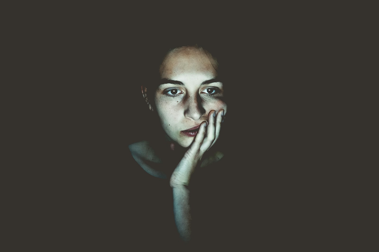 Woman with head resting on hand