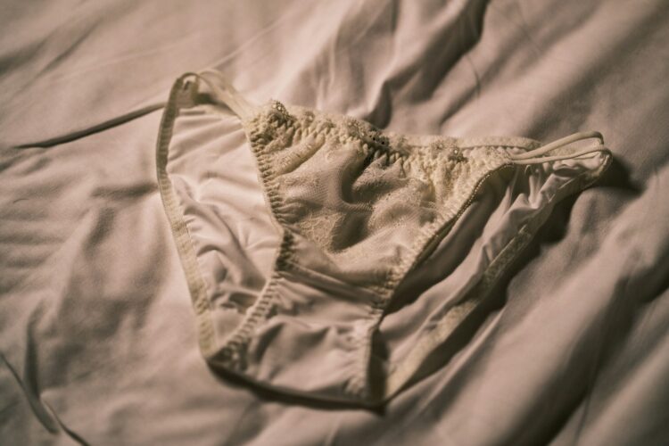 A bra that is laying on a bed