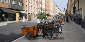 A row of bikes parked on the side of a street