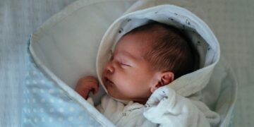 baby in white and gray blanket