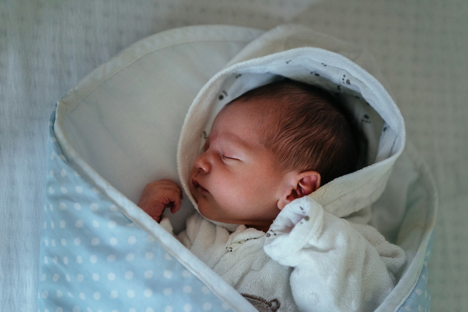 Baby in white and gray blanket