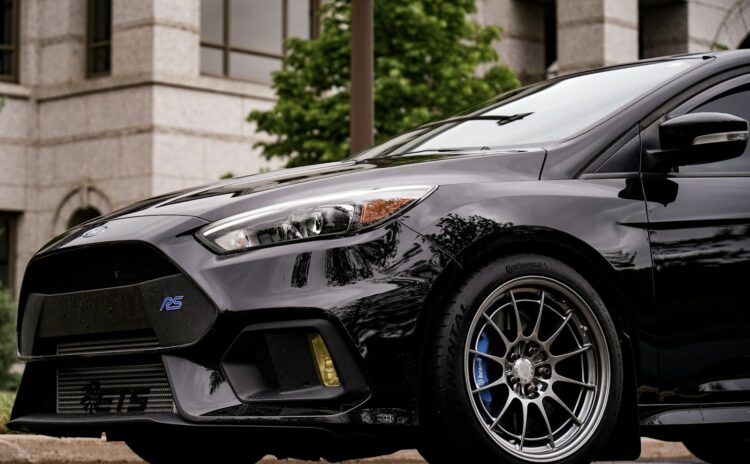 A black car parked on the side of the road