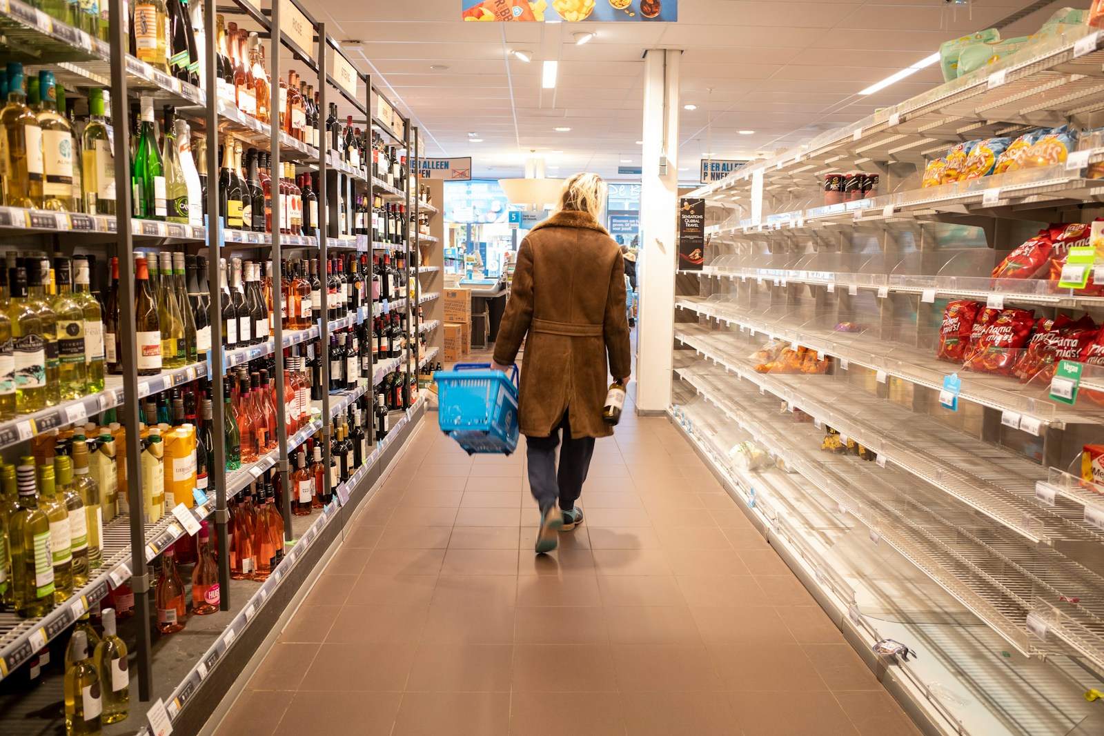 Woman in brown coat walking on hallway