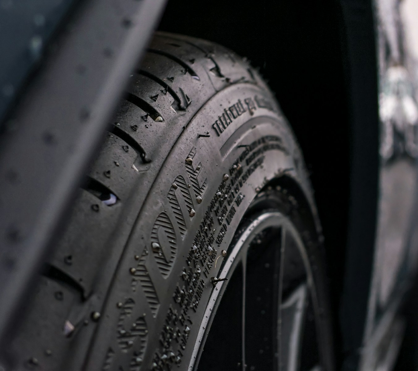 Black and gray wheel with tire