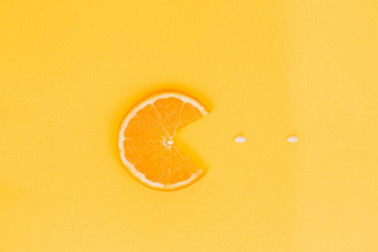 Orange fruit on yellow surface